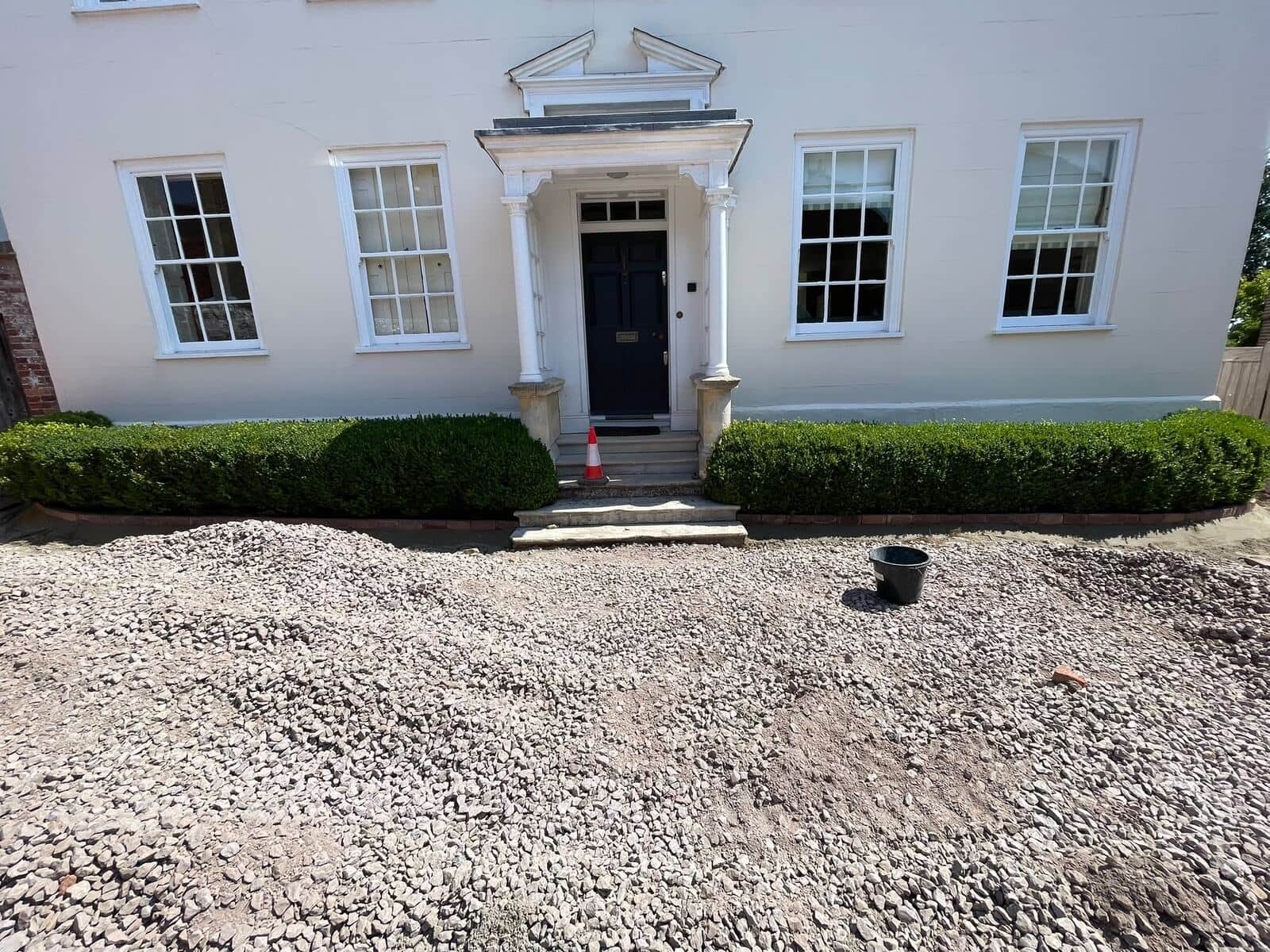 Gravel driveway installation in front of a private residence